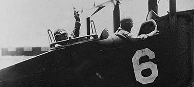 two men in an antique plane (black & white image)