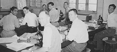 7 researchers in a classroom (Black & white image)